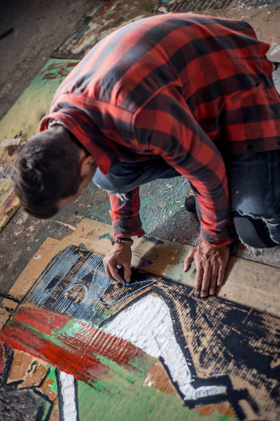 istock Artist Painting Canvas Cardboard On Floor 884992912