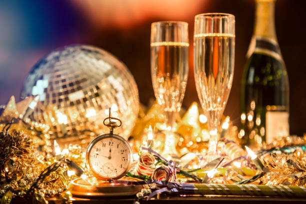 New Year's Eve holiday party, pocket watch, clock at midnight. New Year's Eve holiday party with sparkling wine, disco ball, decorations. new years 2019 stock pictures, royalty-free photos & images