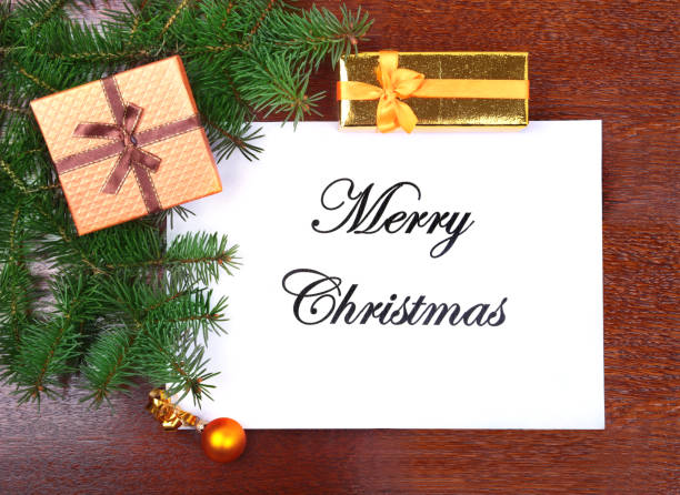 istock gift box, colorful balls and christmas tree on a wooden desktop with letter for copy space. 885018372