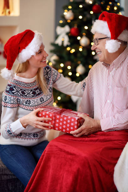 istock cheerful daughter spending Christmas with elderly father 885024512
