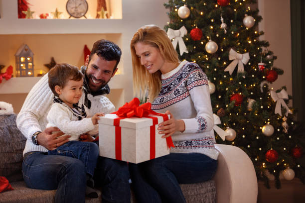 istock family enjoying in Christmas present 885027440