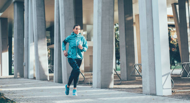 istock Woman jogging outdoors 885027838