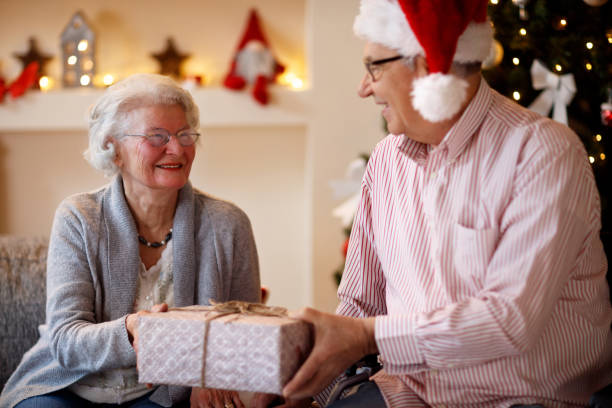 istock senior couple with presents spending Christmas together 885027898