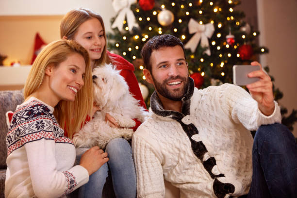 istock Christmas time –family taking selfie 885030030