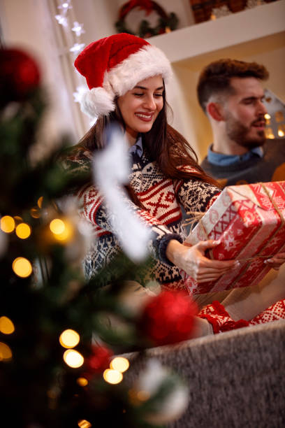 istock happy girl holding Christmas present 885032896