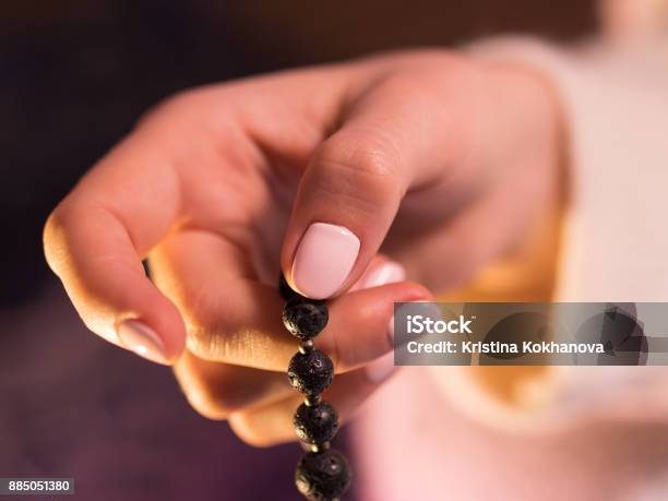 Woman Lit Hand Close Up Counts Malas Strands Of Gemstones Beads Used For Keeping Count During Mantra Meditations Stock Photo - Download Image Now
