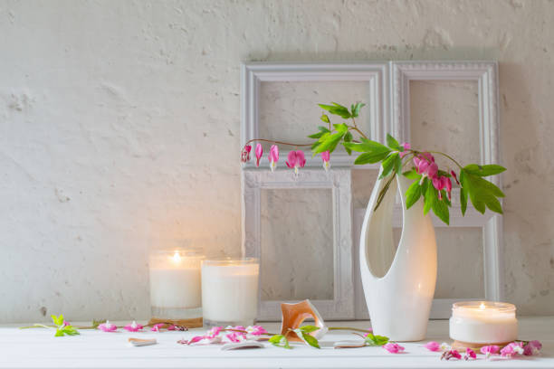 istock flowers in vase with candles on background white wall 885074956