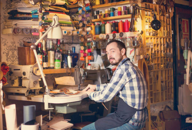 istock Male worker stitching new belt 885075432