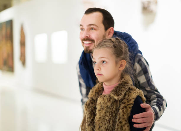 istock Father and daughter looking at expositions 885075480