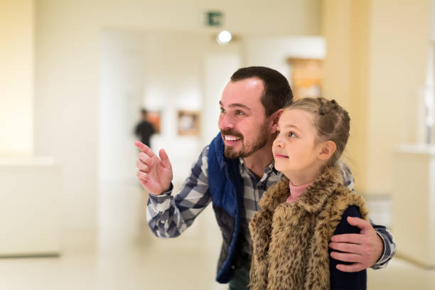 istock young father and daughter exploring expositions in museum 885075486