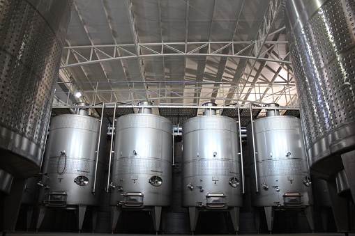 Stainless steel tanks fermenting wine at a winery in Chile