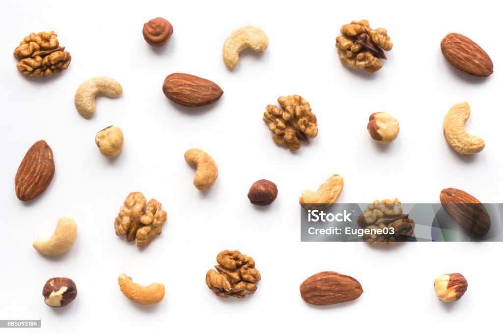 Walnut, cashew, almond and hazelnut on white background. Isolated nuts pattern backdrop. Top view. Nut - Food Stock Photo