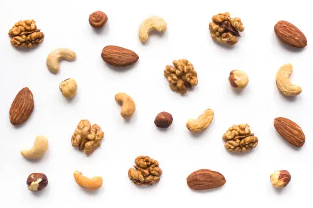 Photo of Walnut, cashew, almond and hazelnut on white background.