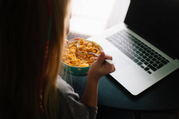 istock Little blond girl having breakfast 885104638