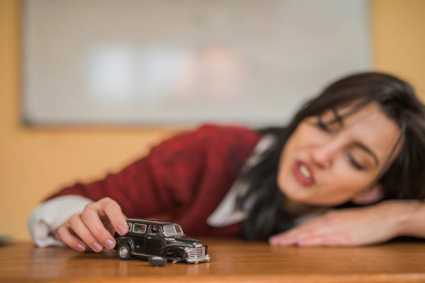 Young woman playing with a car toy.