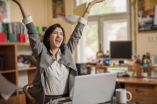 istock Cheerful young woman at her work place. 885112156