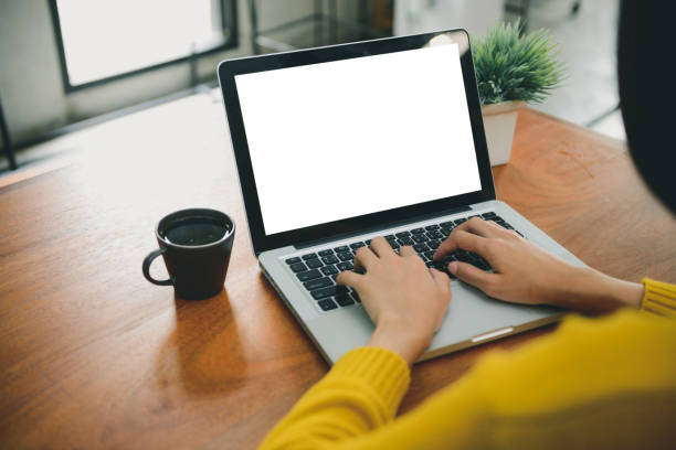 istock Business Technology Concepts - Digital lifestyle working outside office. Woman hands typing laptop computer with blank screen on table in coffee shop. Blank laptop screen mock up for display of design 885117370