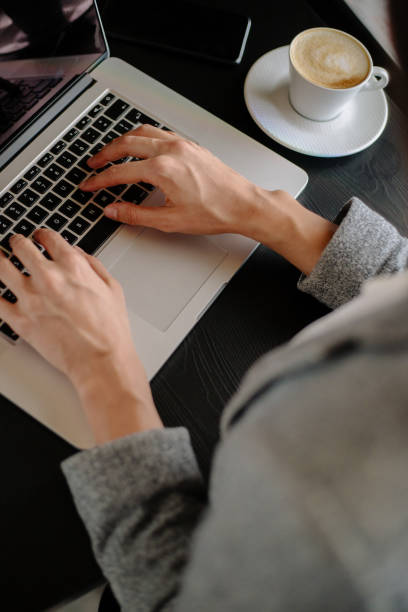 istock Close up of woman typing on lap top 885132606