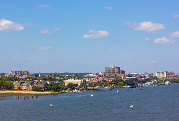 Waterfront Boardwalk on Cape Fear River in Wilmington North Carolina with City Skyline and River Cruise Boats