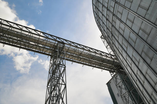 istock Fragment of metal grain elevator in facility with silos. 885172938