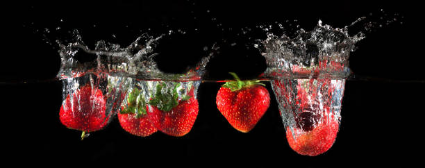 istock Strawberries splashing into water 885177494