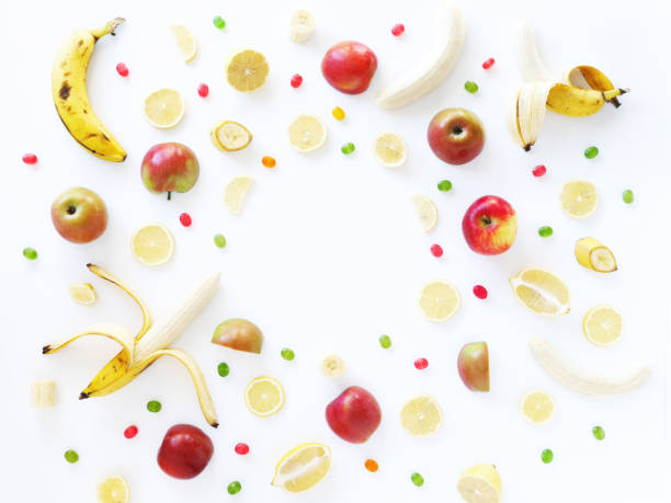 istock Composition of bananas, lemons and apples on a white background, flat layout, top view. Fruit background. Pattern of fruits.Food frame. 885183912