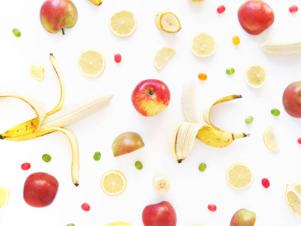 istock Composition of bananas, lemons and apples on a white background, flat layout, top view. Fruit background. Pattern of fruits.Food frame. 885183924