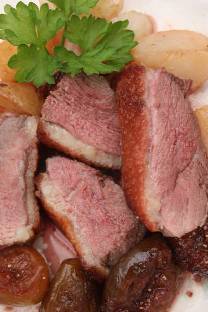 istock Slices of roasted duck breast with turnips and fig 885184570