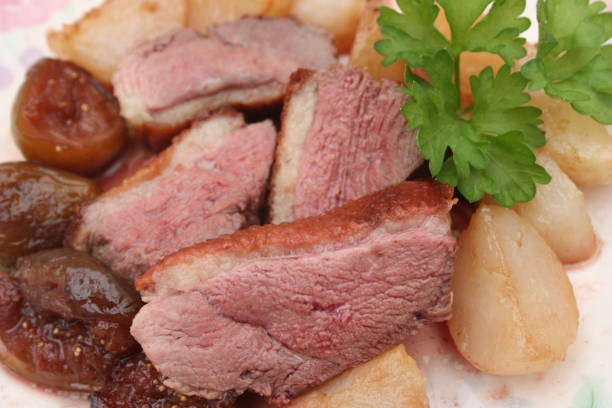 istock Slices of roasted duck breast with turnips and fig 885184572