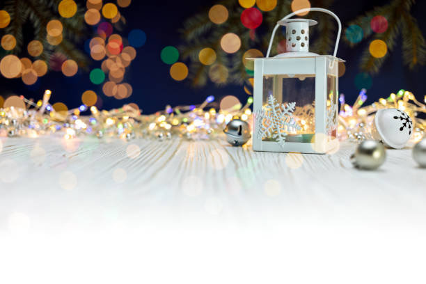istock burning candle lantern and christmas decoration on white wooden background 885196668