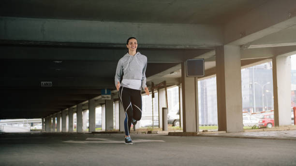 istock Young woman running outdoors 885204828