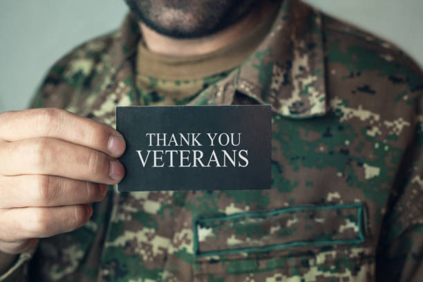 istock Soldier holding card Thank You Veterans. 885209746
