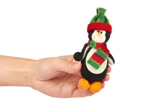 istock penguin Cristmas decoration in hand isolated on white background. New Year object 885227334