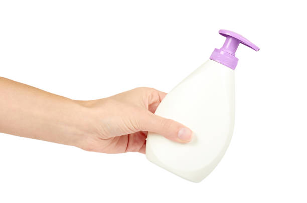 istock White hand sanitizer soap dispenser in hand isolated on white background. Housework and sanitary concept 885231680