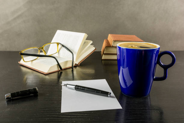 istock Break in reading on a note and a sip of coffee. 885236968