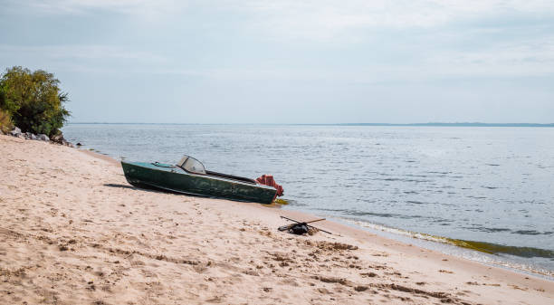istock River landscape. Fishing boat on a deserted shore 885265982