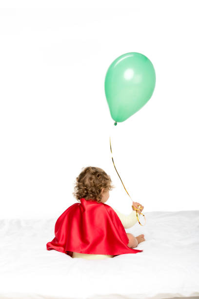 Fluffy red balloon on blue and soft surface.