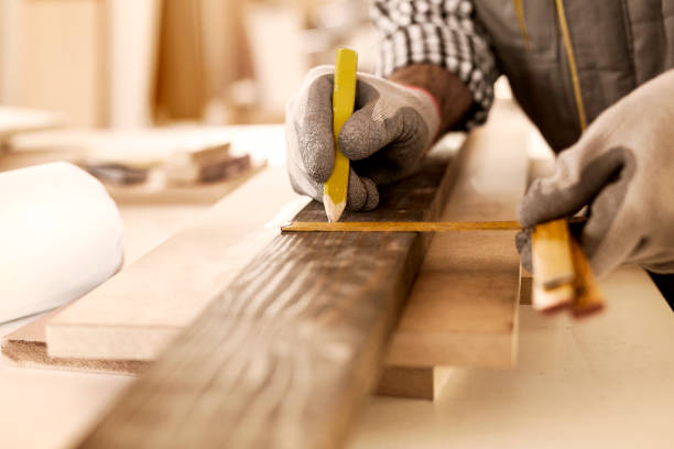 Carpenter taking perfect measurement Senior carpenter taking measurement in his workshop woodshop stock pictures, royalty-free photos & images