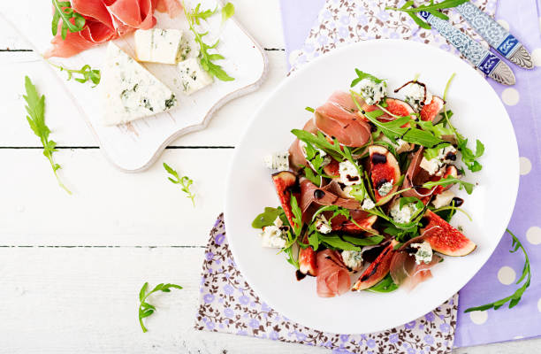 istock Prosciutto di Parma salad with figs and blue cheese. Flat lay. Top view 885306832