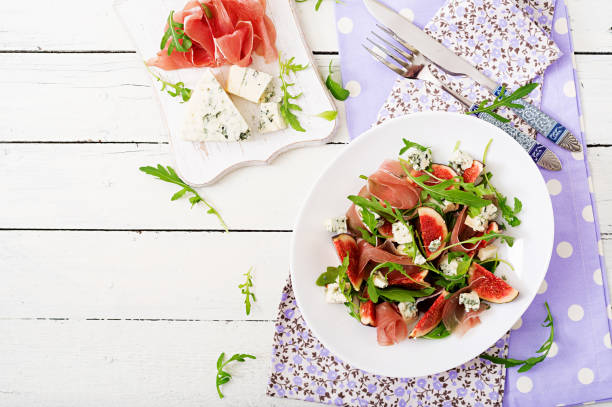 istock Prosciutto di Parma salad with figs and blue cheese. Flat lay. Top view 885306844