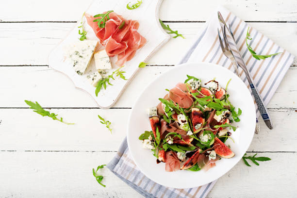 istock Prosciutto di Parma salad with figs and blue cheese. Flat lay. Top view 885306846