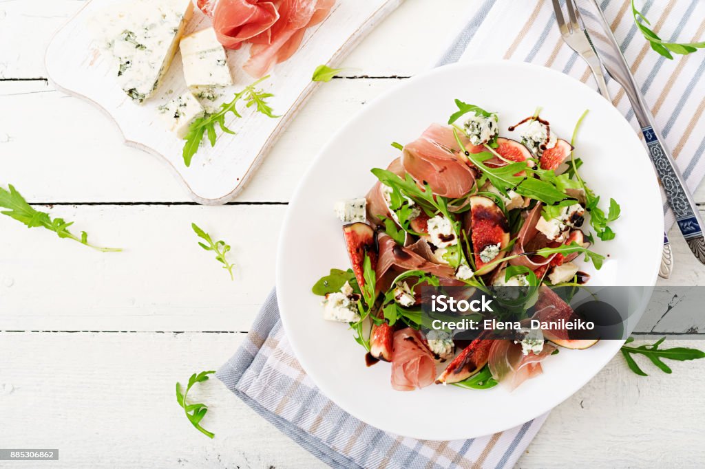 Prosciutto di Parma salad with figs and blue cheese. Flat lay. Top view Salad Stock Photo