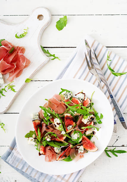 istock Prosciutto di Parma salad with figs and blue cheese. Flat lay. Top view 885306870