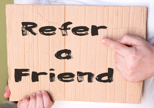 istock Refer a Friend card isolated on cardboard 885311182