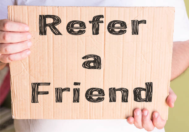 istock Refer a Friend card isolated on cardboard 885311622