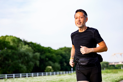 Health conscious Japanese man with positive vibes jogging in the morning