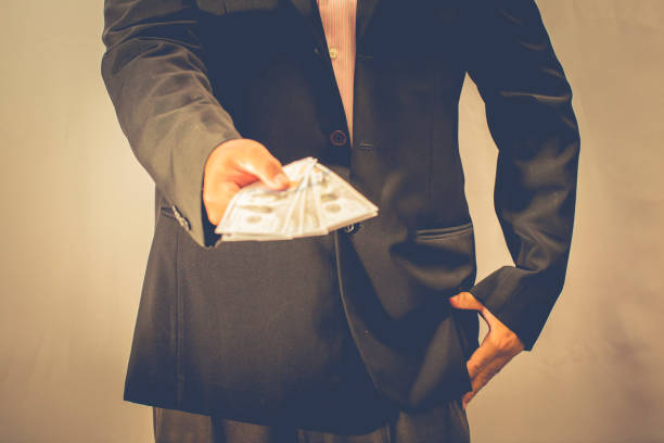 istock businessman is showing his money 885320064