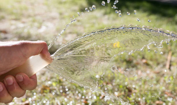 istock water from the hose outdoors 885320422