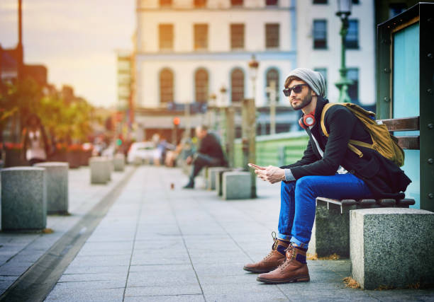 Shot of a young man using his mobile phone while out in the city