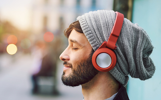 Cropped shot of a young man listening to music out in the city